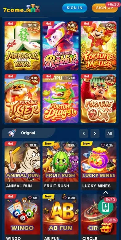 A player's hand holding a smartphone showing a winning Teen Patti hand on 7Come Game, with a cup of tea in the background, creating a relaxed and exciting personal gaming moment.